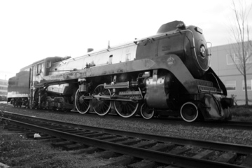 Black-and-white photograph of the Royal Hudson steam locomotive on railway tracks.